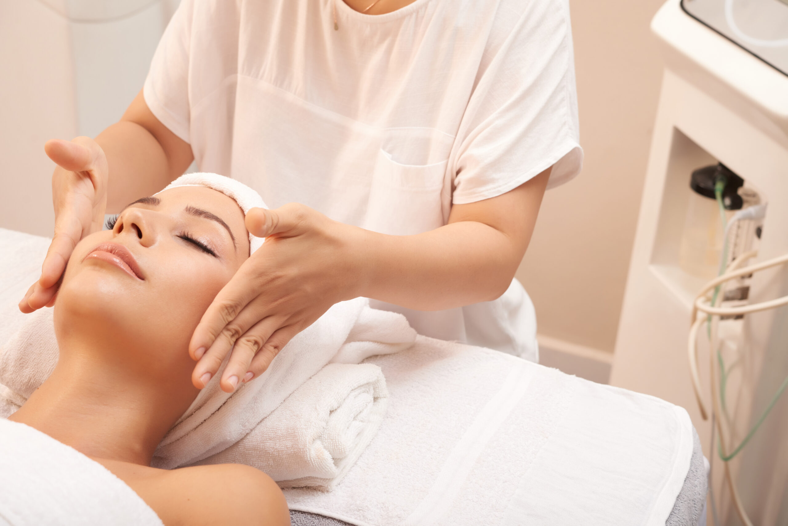 Esthetician vs Aesthetician performing skin analysis
